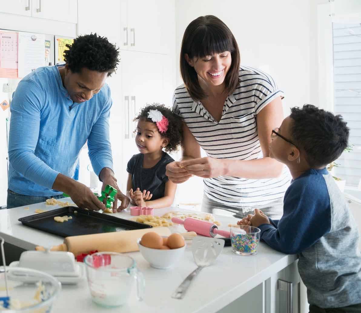 A family of four, baking together